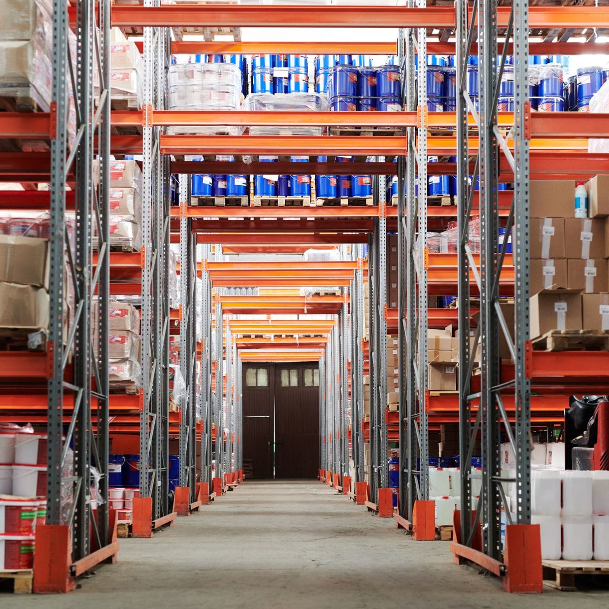 Narrow-aisle warehouse racking stacked with boxed finished goods