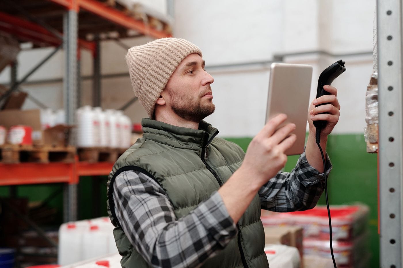 Warehouse worker managing rental inventory with a handheld scanner